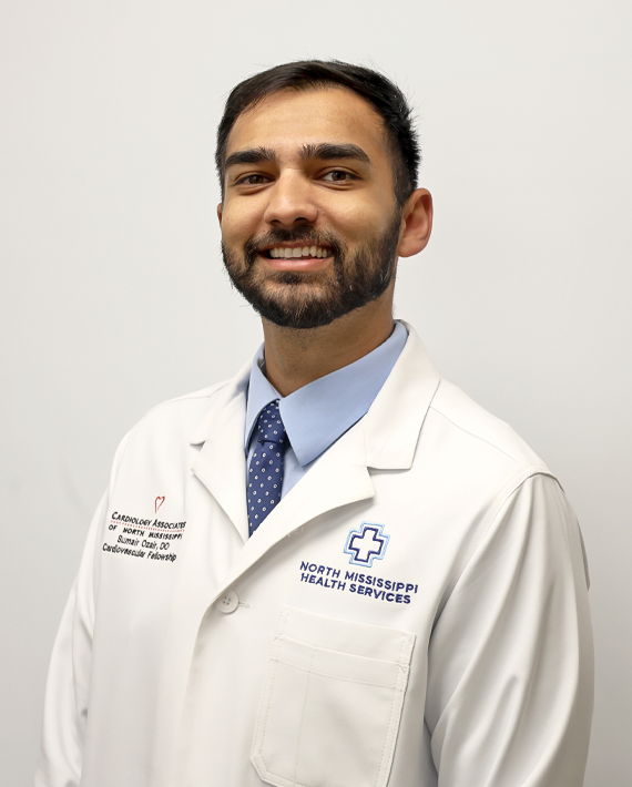 A man wearing a lab coat, tie, and shirt, with logos and text for North Mississippi Health Services.