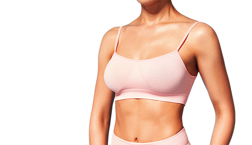 A person wearing a pink sports bra and matching leggings, focusing on the torso.